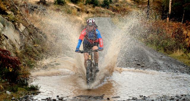 Mountain biker splashing through a stream