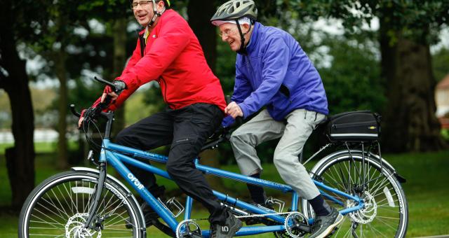 Two men cycling on a tandem