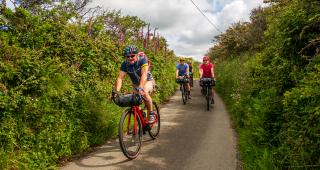 Rob Penn (freelance journalist), Katherine Moore (Unpaved podcast), Vedangi Kulkarni (freelance) and Sophie Gordon (Cycling UK) ride along typical Cornish lanes during a recce ride of Cycling UK's West Kernow Way