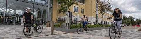 People with bikes outside an office building