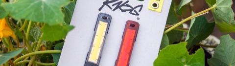 A set of Knog Plus bike lights sat in nasturiums