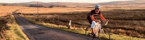 Man cycling on the road through the Scottish borders (c) Graham Dawson/Chase the Sun