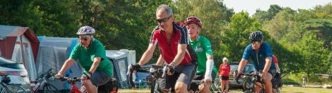Group cycling through campsite