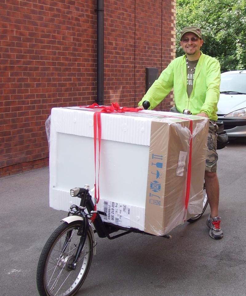 A man with a laden e-cargo bike