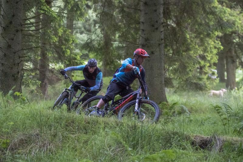 Two mountain bikers descending down the Bloody Bush MTB trail. Photo Joolze Dymond / Cycling UK