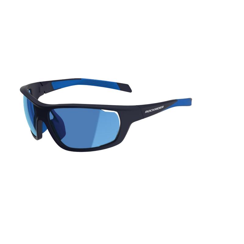A pair of cycling sunglasses with black and blue full frames and blue lenses. The word 'Rockrider' is on the arm in white.