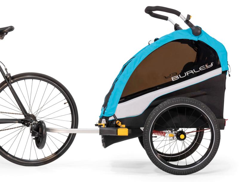 The Burley D’Lite X child trailer shown attached to the back wheel of a bike