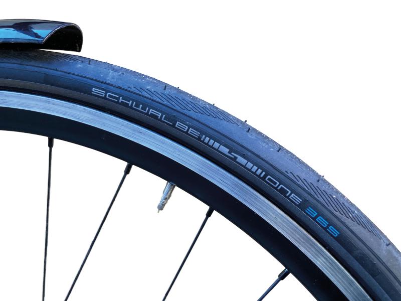 A close-up of the Schwalbe One 365 tyre, showing the logo, on a bike wheel
