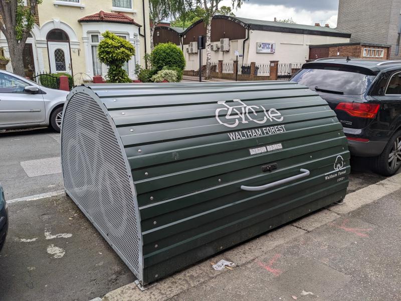 A green bike hangar with a cycle logo and the words Waltham Forest on it