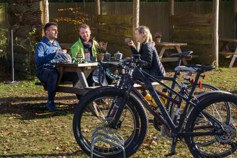 Cyclists enjoying a rest stop at an outdoor cafe.