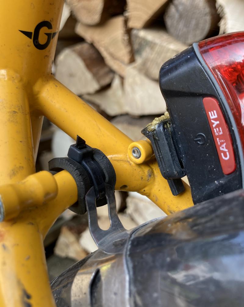A close up of a mudguard attachment to a cycle frame