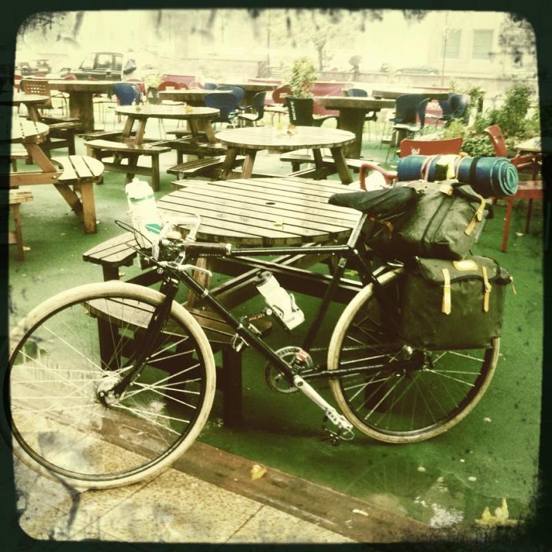 A bicycle rests against a table