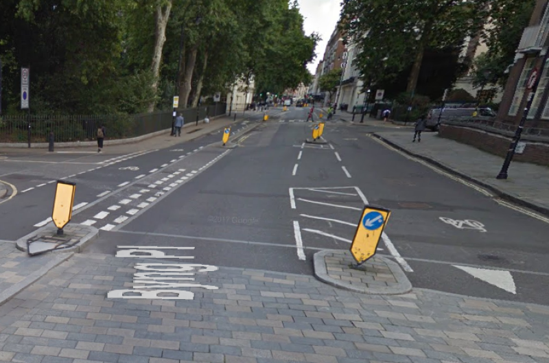 Give-way line for drivers turning into a side road, Torrington Place, London - but it doesn't conform to UK signing rules!