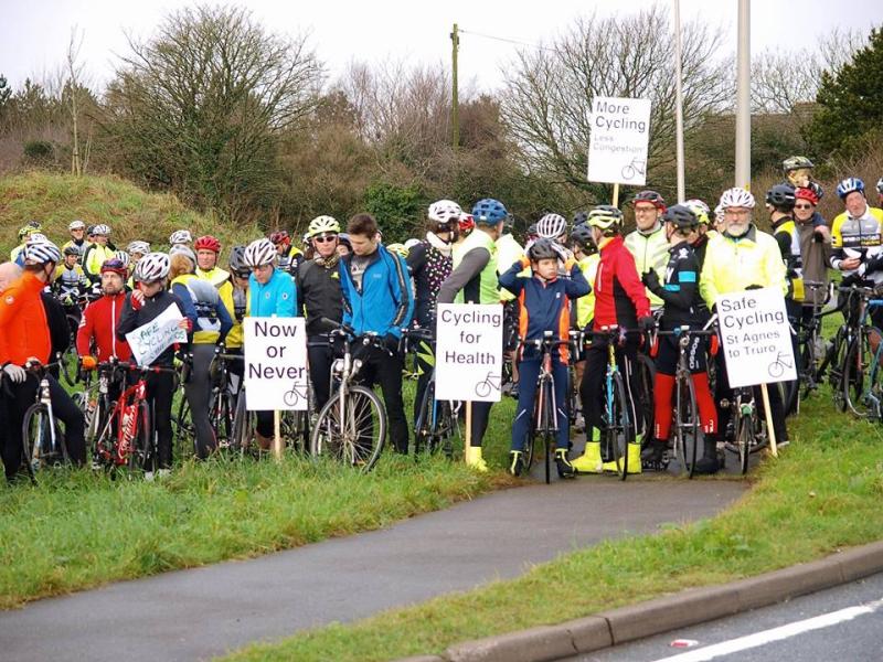 Group of cyclists holding placards