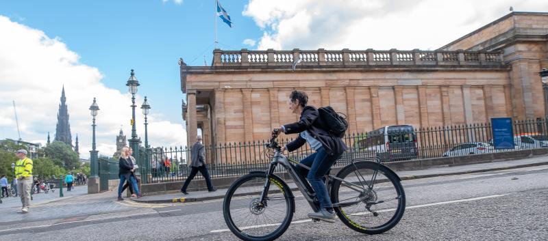 Woman riding an e-bike in Edinburgh
