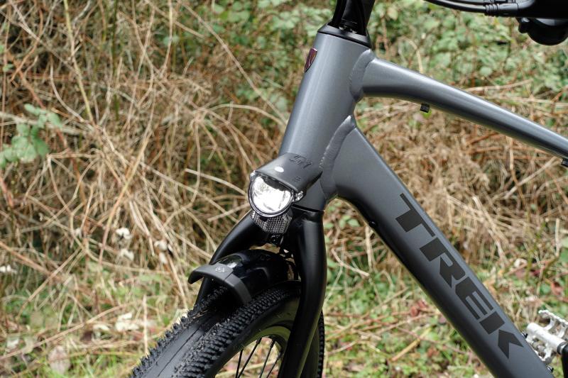 A bicycle light at the top of the forks of a bicycle