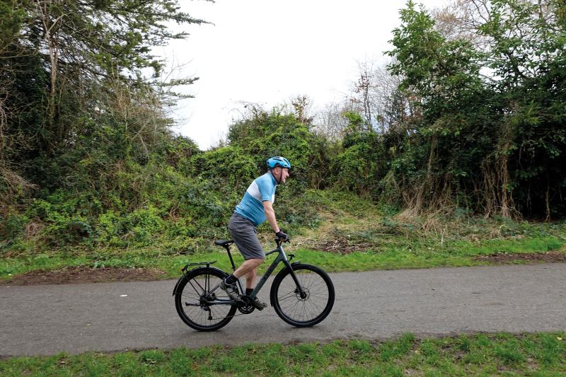 A man cycles along a path on an off-road bicycle