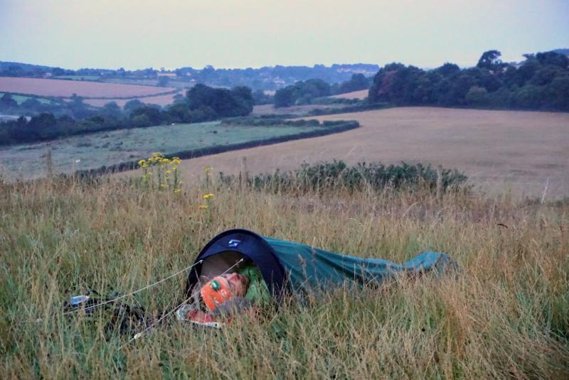 A man sleeps in a hooped bivvy bag