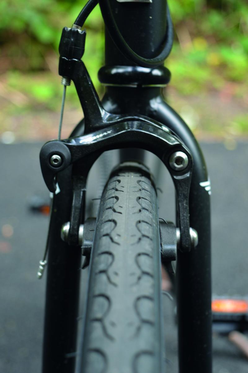 Front-on view of a bike wheel underneath traditional V brakes