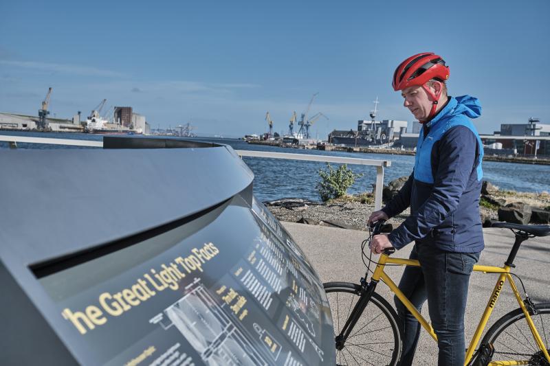 A man reads from an information board