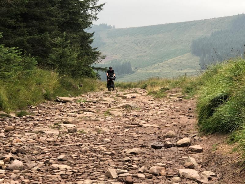 Cyclist riding over gravel