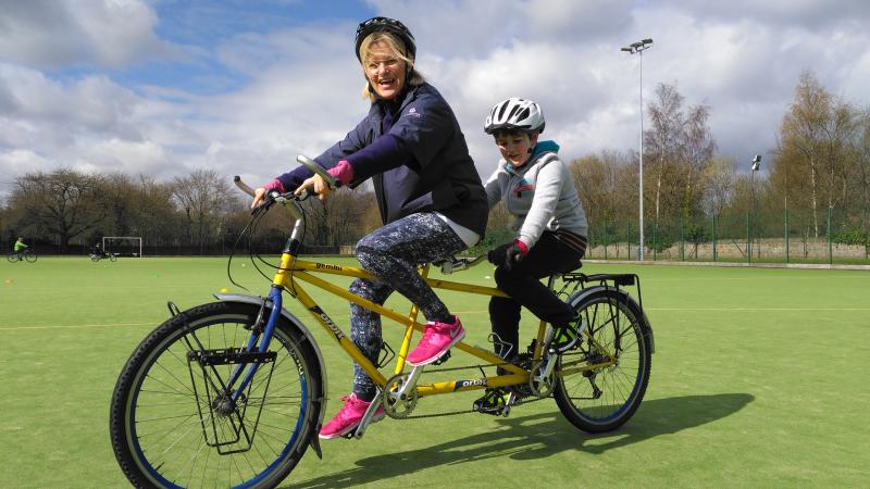 Women and boy on a tandem bike