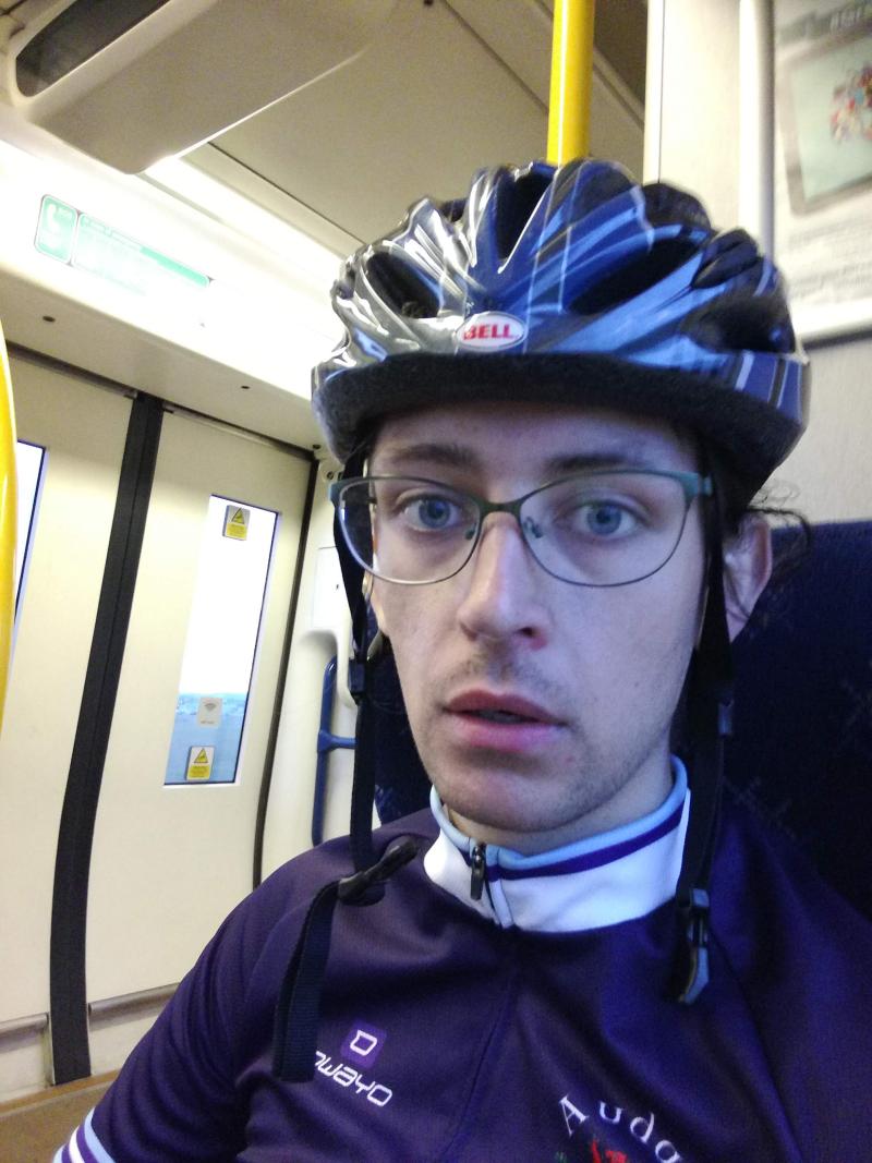 Esmond looking tired on a train after a long ride