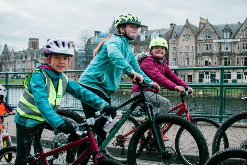 Children cycling alongside the river Ness in Inverness as part of a Kidical Mass ride