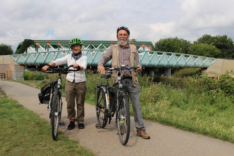 Two people standing with bikes on a traffic free trail