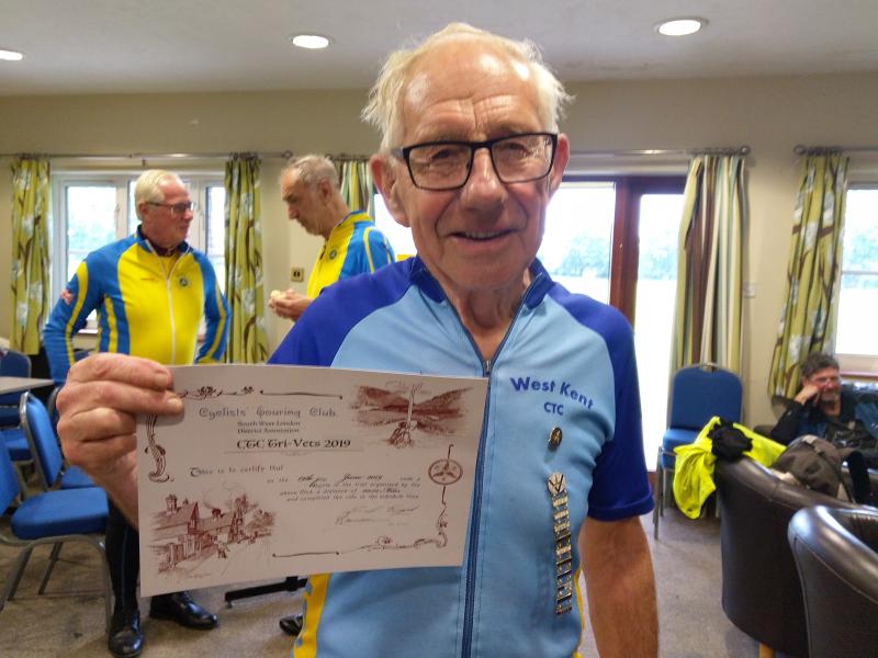 John Seabrook with his badges and certificate