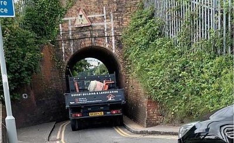 A truck squeezes through a narrow bridge in Poole