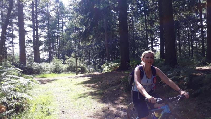 Laura riding through the woods above Holmwood