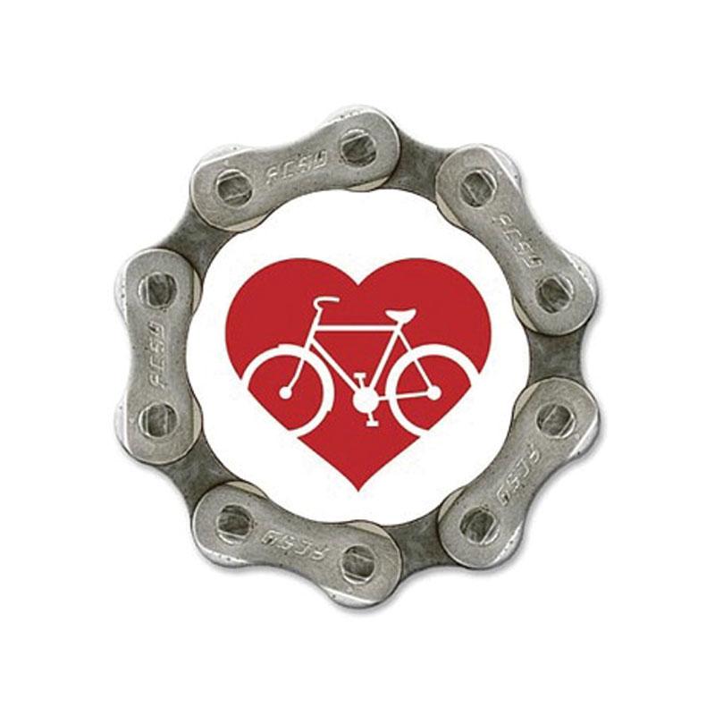 A fridge magnet made from bicycle cog with a red heart logo in the centre