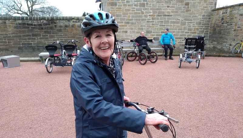Mary Douglas smiling on her bike