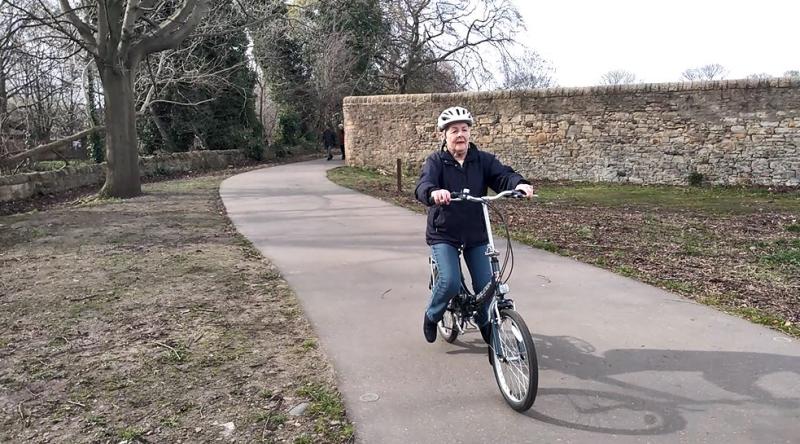 Mary gliding on a bike with pedals removed
