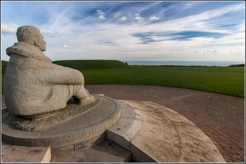 Statue of seated man looking out to sea