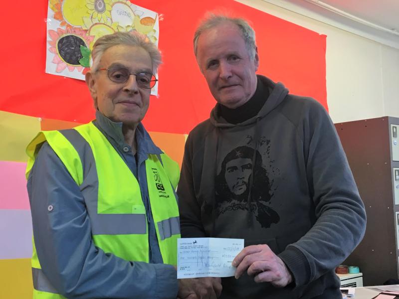 Derek Gould presents a cheque to Eastham Centre volunteer Paul Green