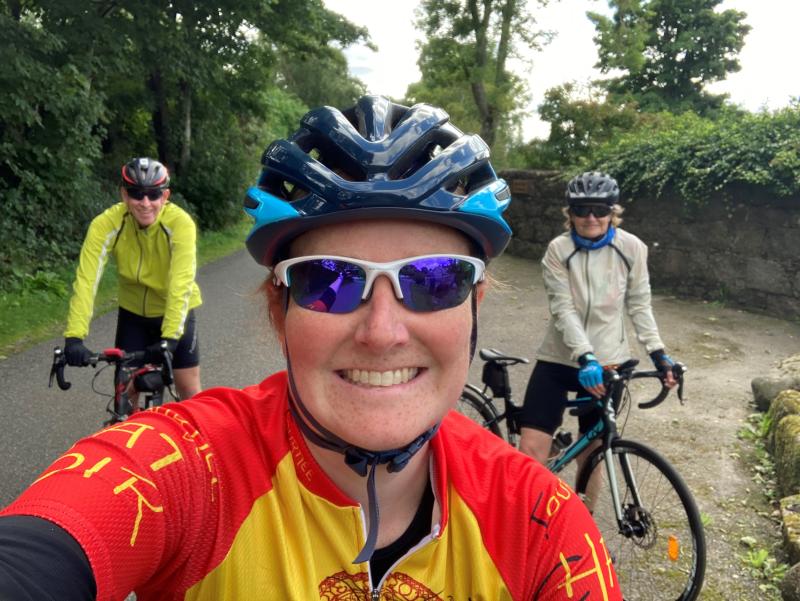 Woman with parents all on road bikes in rural setting