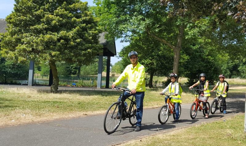 Nasaar leading children on a ride