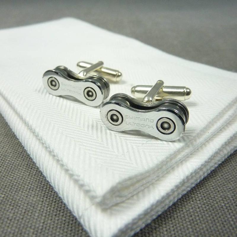 A set of silver cufflinks on a white towel