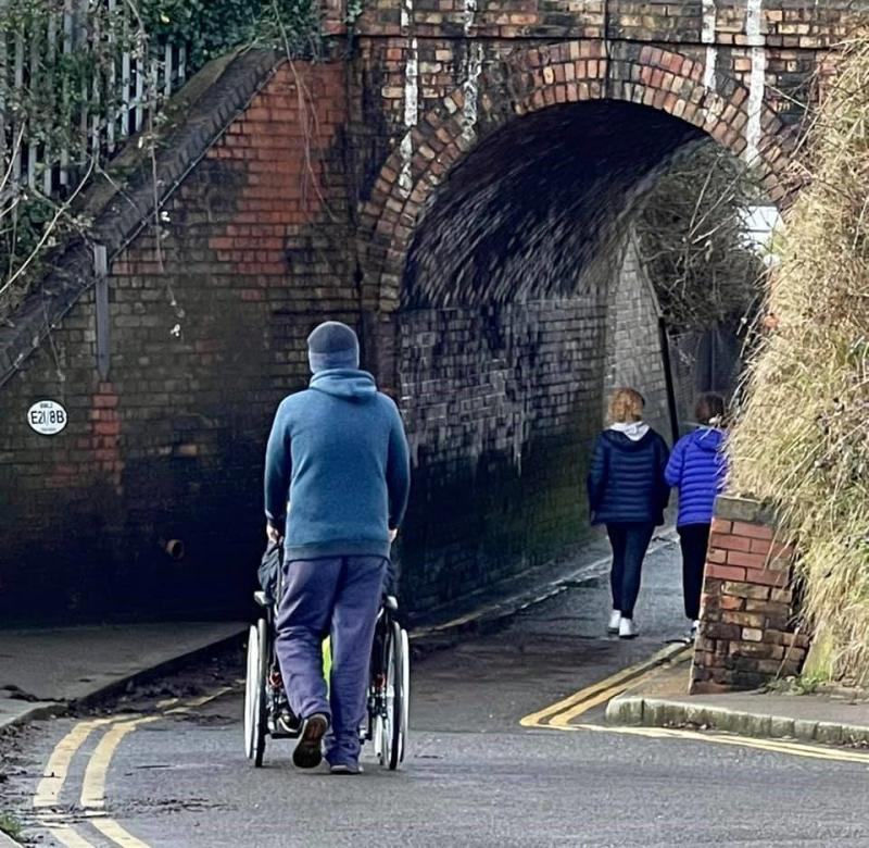 A wheelchair user passing under the Keyhole Bridge