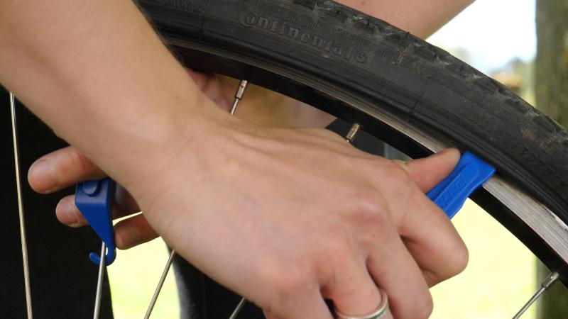 Use a pair of levers to remove the tyre