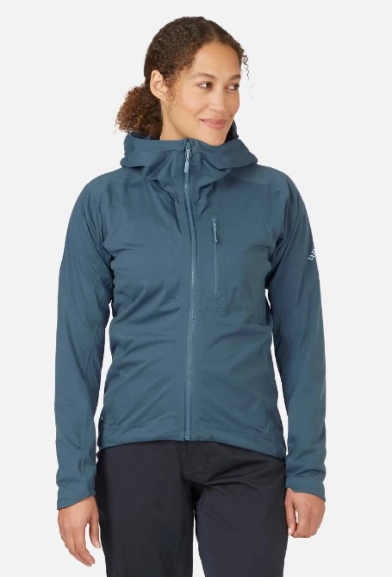 Woman models Rab Cinder Kinetic waterproof jacket in orion blue