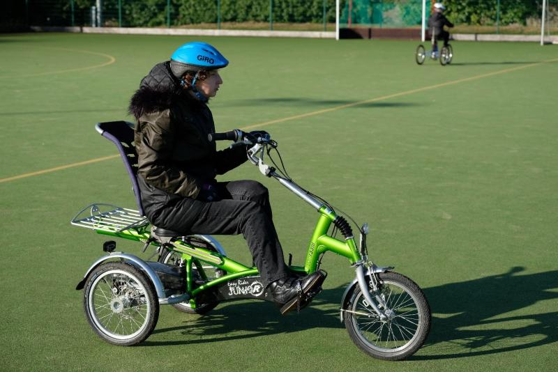 Woman riding trike on playing field