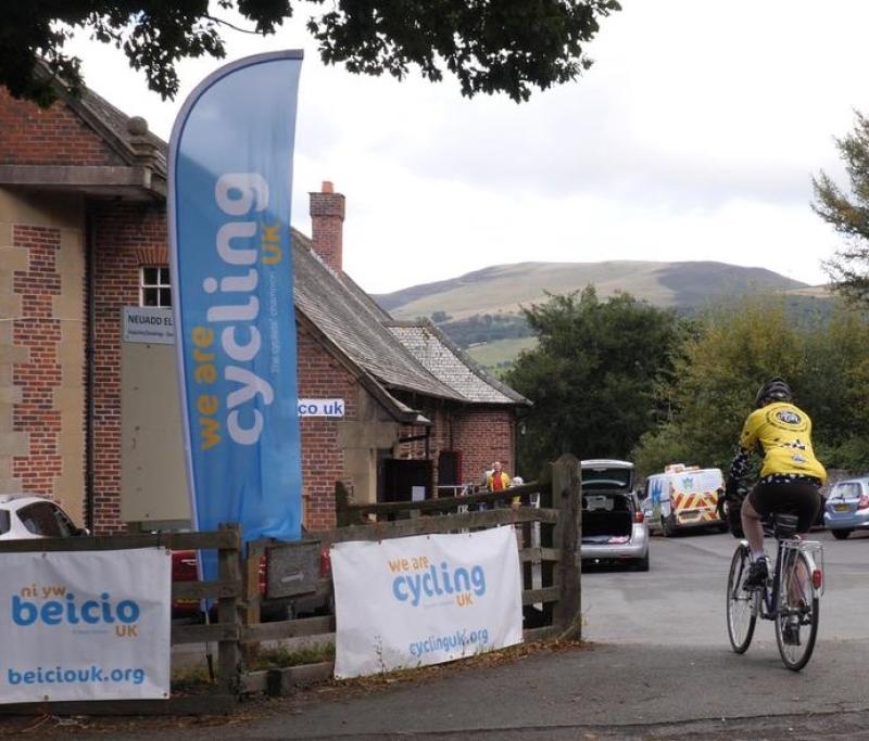 A rider arriving at the village hall for the buffet lunch.  Photo by Robby Spanring, Cycling UK