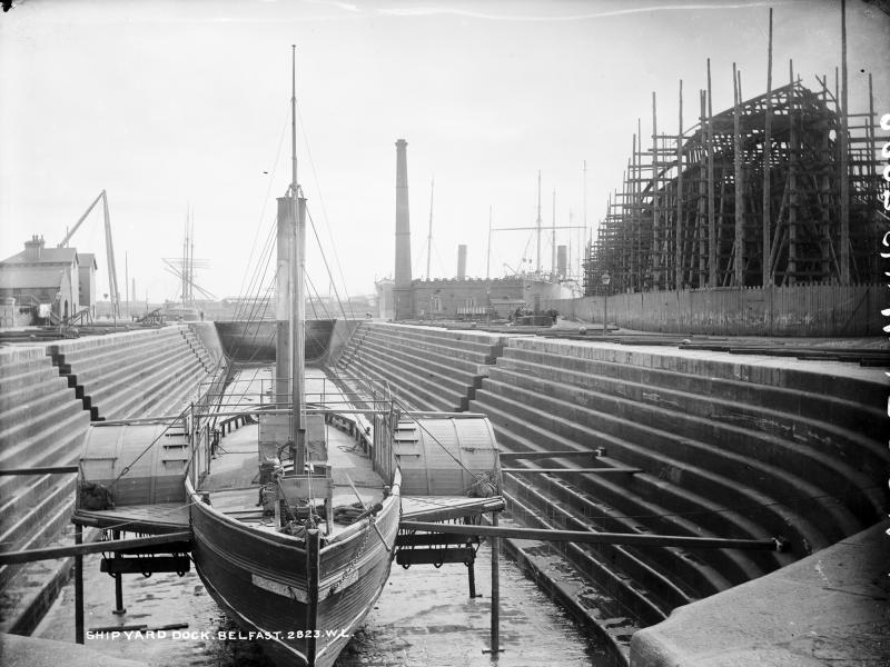 Black and white photo of a ship in a graving dock in Belfast