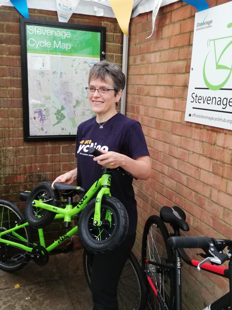 Jill Borcherds with the poster displayed on the wall of the Cycle Hub