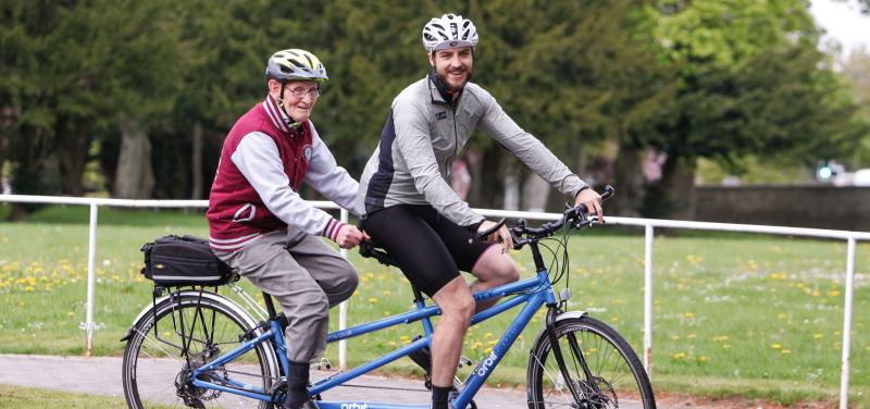 Two men riding a tandem