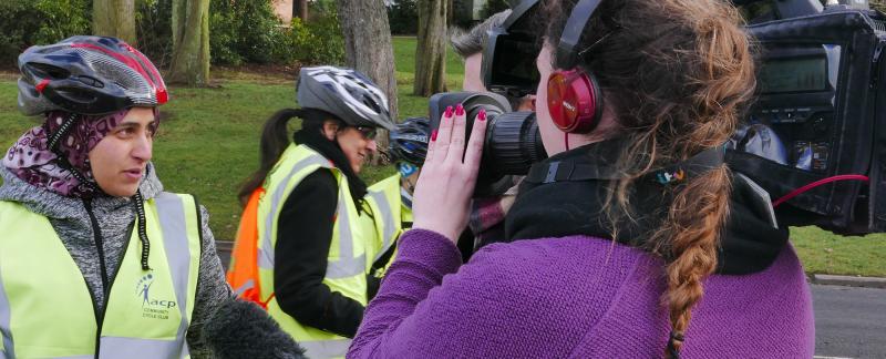 TV news crew interviewing a cyclist