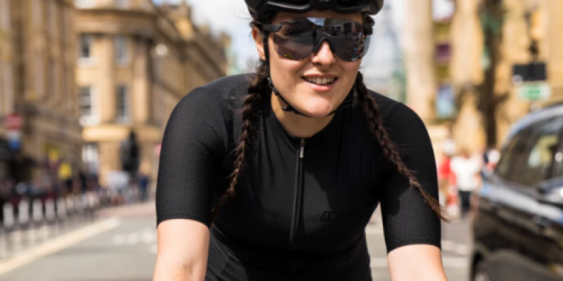 Woman cycling while wearing Attacus onyx black evo jersey © Attacus